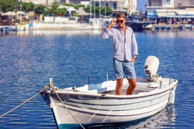young man fashion photoshoot at the beach sunny day
