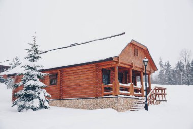 Kış kış orman yanındaki ahşap ev