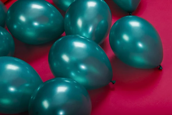 colorful green balloons on a pink background party