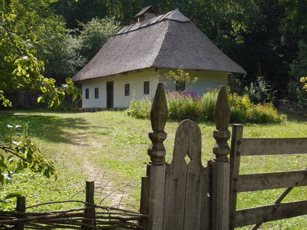 Old traditional Ukrainian village houses.Typical rural architecture. Summer outdoor landscape. Historical heritage. Village Pirogovo.