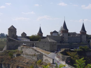 Medieval castle in the city of Kamyanets-Podilsky, Ukraine .  It is a formidable, strong fortress, whose walls are cut out of solid rock. The fortress stands at the top of a precipitous cliff . 