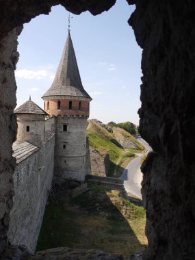 Medieval castle in the city of Kamyanets-Podilsky, Ukraine .  It is a formidable, strong fortress, whose walls are cut out of solid rock. The fortress stands at the top of a precipitous cliff . 