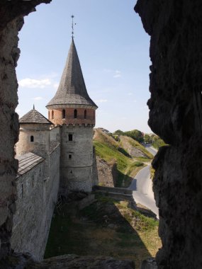 Medieval castle in the city of Kamyanets-Podilsky, Ukraine .  It is a formidable, strong fortress, whose walls are cut out of solid rock. The fortress stands at the top of a precipitous cliff . 