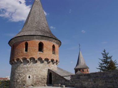Medieval castle in the city of Kamyanets-Podilsky, Ukraine .  It is a formidable, strong fortress, whose walls are cut out of solid rock. The fortress stands at the top of a precipitous cliff . 