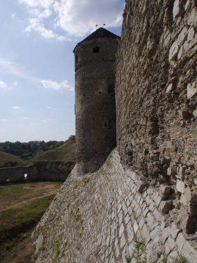 Medieval castle in the city of Kamyanets-Podilsky, Ukraine .  It is a formidable, strong fortress, whose walls are cut out of solid rock. The fortress stands at the top of a precipitous cliff . 
