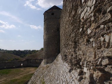 Medieval castle in the city of Kamyanets-Podilsky, Ukraine .  It is a formidable, strong fortress, whose walls are cut out of solid rock. The fortress stands at the top of a precipitous cliff . 