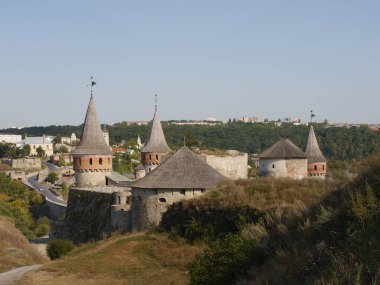 Medieval castle in the city of Kamyanets-Podilsky, Ukraine .  It is a formidable, strong fortress, whose walls are cut out of solid rock. The fortress stands at the top of a precipitous cliff . 