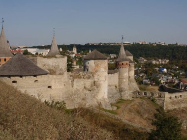 Medieval castle in the city of Kamyanets-Podilsky, Ukraine .  It is a formidable, strong fortress, whose walls are cut out of solid rock. The fortress stands at the top of a precipitous cliff . 