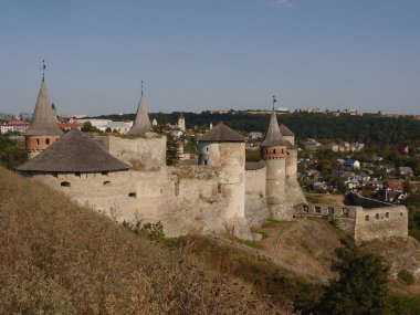 Medieval castle in the city of Kamyanets-Podilsky, Ukraine .  It is a formidable, strong fortress, whose walls are cut out of solid rock. The fortress stands at the top of a precipitous cliff . 