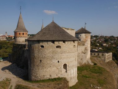 Medieval castle in the city of Kamyanets-Podilsky, Ukraine .  It is a formidable, strong fortress, whose walls are cut out of solid rock. The fortress stands at the top of a precipitous cliff . 