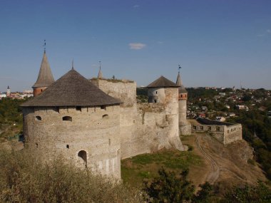 Medieval castle in the city of Kamyanets-Podilsky, Ukraine .  It is a formidable, strong fortress, whose walls are cut out of solid rock. The fortress stands at the top of a precipitous cliff . 