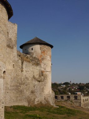 Medieval castle in the city of Kamyanets-Podilsky, Ukraine .  It is a formidable, strong fortress, whose walls are cut out of solid rock. The fortress stands at the top of a precipitous cliff . 