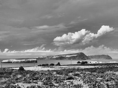 Views of the caldera, mountains, the Mediterranean Sea, and the city of Fira from the Akrotiri Lighthouse Santorini Greece. Black and white foto. Special art effect.