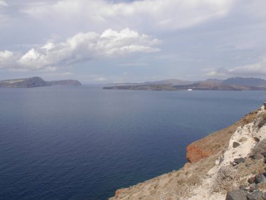 Views of the caldera, mountains, the Mediterranean Sea, and the city of Fira from the Akrotiri Lighthous, Santorini island Greece.