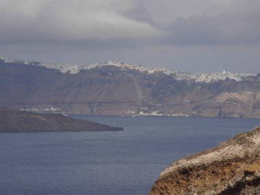 Views of the caldera, mountains, the Mediterranean Sea, and the city of Fira from the Akrotiri Lighthous, Santorini island Greece.