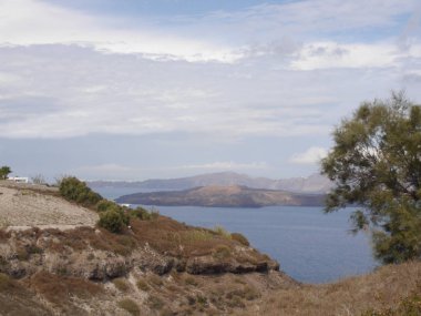 Views of the caldera, mountains, the Mediterranean Sea, and the city of Fira from the Akrotiri Lighthous, Santorini island Greece.