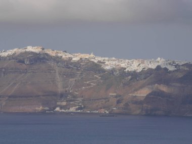 Views of the caldera, mountains, the Mediterranean Sea, and the city of Fira from the Akrotiri Lighthous, Santorini island Greece.