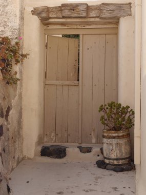 Ancient entrance doors of historic houses in Emporio, the largest village of Santorini island,Greece. clipart