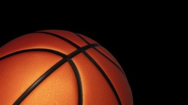 Basketbol oyunu için yavaş dönen turuncu topun animasyonu. Siyah zemin üzerinde ışık ve gerçekçi dokusu olan, pürüzsüz döngü.