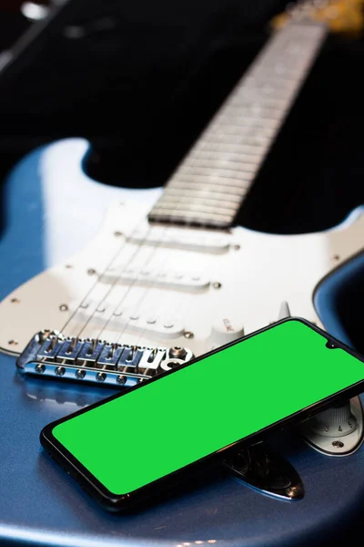 Electric guitar. Green chroma mobile phone