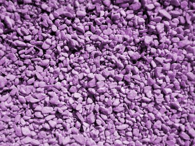 Mor arka planda küçük çakıl taşlarının yüzeyi