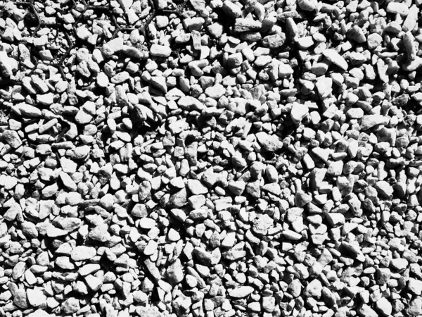 The surface of small pebbles in black and white, background