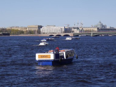 Saint Petersburg / Russia - 05.09.2018: The view from the boat from the water of Neva River to the city during the sunny day under the blue sky.