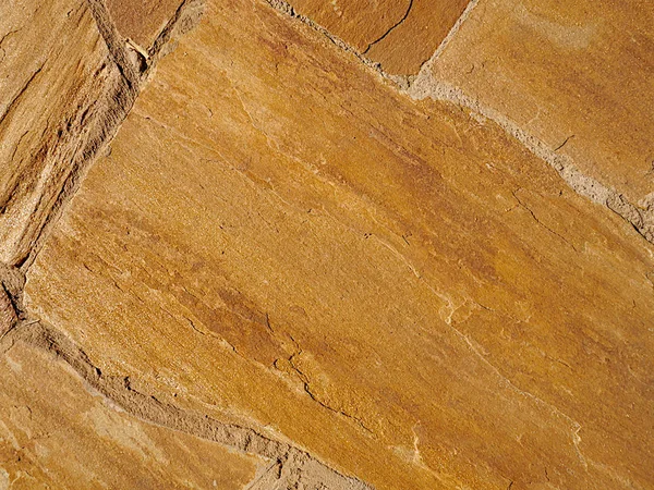 Ocher, taş levhalardan yapılmış altın masonluk arka plan, doku