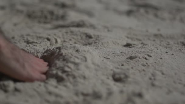 Close up shot on a man hand touching the sand beach. Slow motion real life — Stock Video