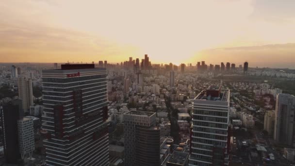 Tel aviv skyline at orange sunset. Horizon view of towers and buildings towards sun. Downtown landscape of modern city background — Stock Video