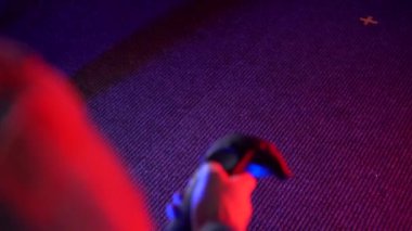 Futuristic concept: Close up man using augmented reality equipment. Adult holding virtual reality controllers. Futuristic rgb lights