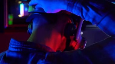 Futuristic concept: Close up man using augmented reality equipment. Adult enjoying virtual reality video head set. Playing video games in vr.