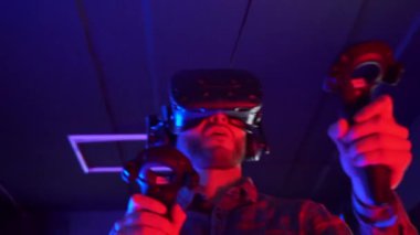 Futuristic concept: Close up man using augmented reality equipment. Adult enjoying virtual reality video head set. Playing video games in vr.