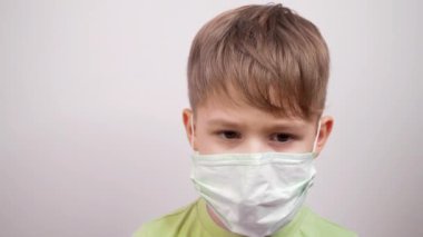 Coronavirus konsepti: cerrahi maskeli çocuk. Wuhan 'daki bakteri salgınına karşı koruma. Hasta üzgün çocuğun portresi. Virüs yayılmasına karşı