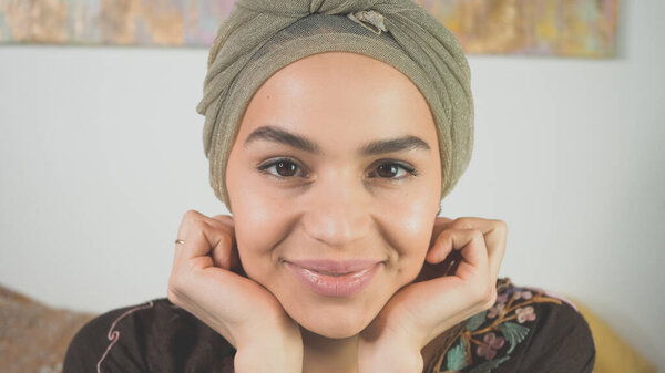 Exotic attractive mixed race woman smiling and looking into camera. New age, esoteric, astrology, magic, witch, occult concept. Beautiful female with very handsome muslim features.