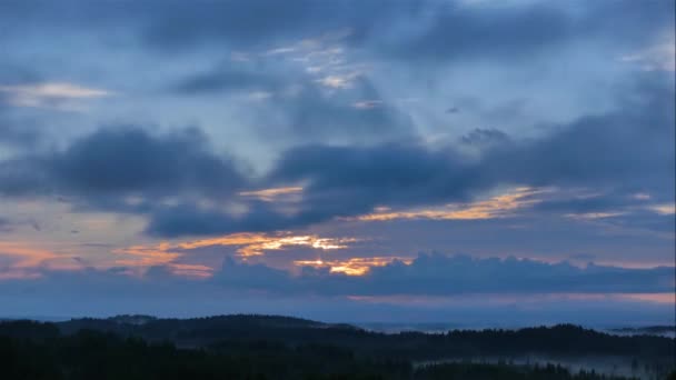 在暮色的天空中 时间从史诗般的夕阳西下 滑落在蔚蓝的云彩中 从山顶俯瞰青翠的山谷和森林 — 图库视频影像