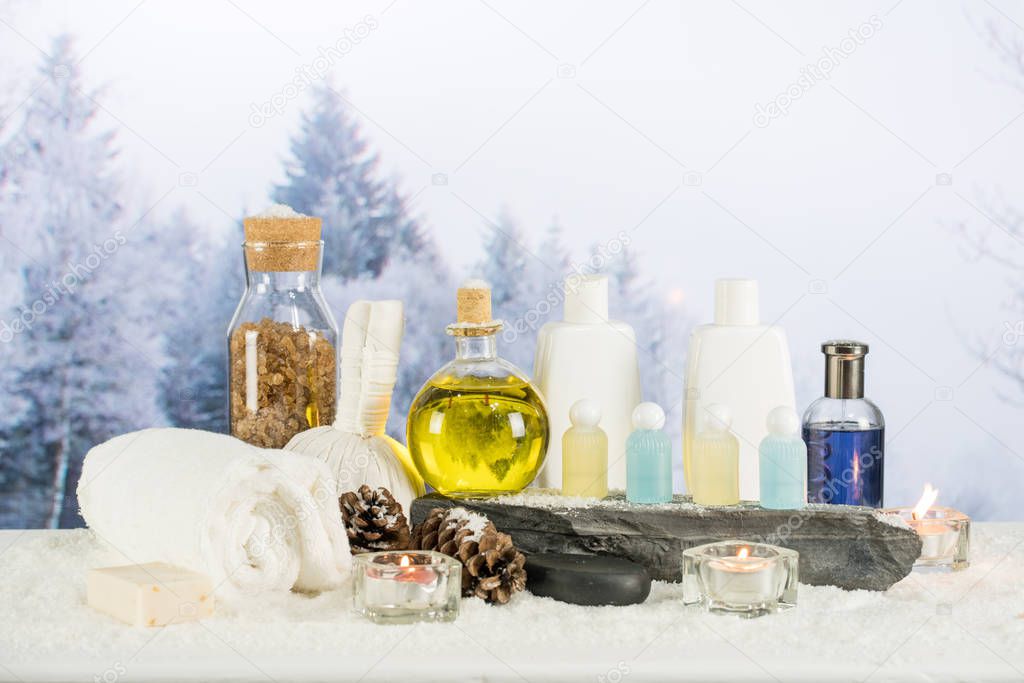 Close up of beauty and fashion concept with spa setting for wellness center. Beautiful composition of spa cosmetic products concept, massage and treatment in winter with snowflake and pine cones