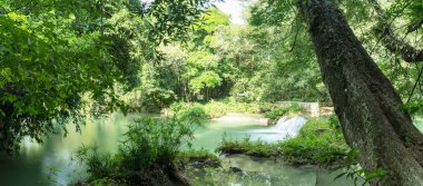 Chet Sao Noi Waterfall in tropical rainforest with rock and turquoise blue pond has 7 tiers, Seven leveled falls are one of most beautiful waterfalls in Thailand.  Namtok chet saonoi National Park