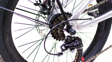 Close up wheel and chain of mountain biking. Landscape view of disc break system and front Derailleur of moutain bike. bicycle parts titanium color and frame aluminium. Shift lever and brake lever.