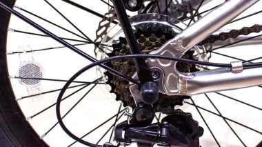 Close up wheel and chain of mountain biking. Landscape view of disc break system and front Derailleur of moutain bike. bicycle parts titanium color and frame aluminium. Shift lever and brake lever.