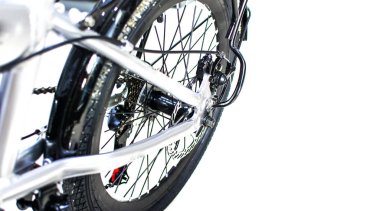 Close up wheel and chain of mountain biking. Landscape view of disc break system and front Derailleur of moutain bike. bicycle parts titanium color and frame aluminium. Shift lever and brake lever.