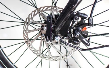 Close up wheel and chain of mountain biking. Landscape view of disc break system and front Derailleur of moutain bike. bicycle parts titanium color and frame aluminium. Shift lever and brake lever.