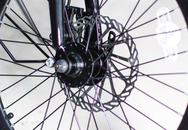 Close up wheel and chain of mountain biking. Landscape view of disc break system and front Derailleur of moutain bike. bicycle parts titanium color and frame aluminium. Shift lever and brake lever.