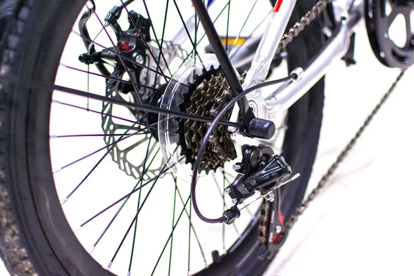 Close up wheel and chain of mountain biking. Landscape view of disc break system and front Derailleur of moutain bike. bicycle parts titanium color and frame aluminium. Shift lever and brake lever.