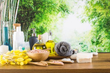 Close up of beauty and fashion concept with spa setting for wellness center. Beautiful composition of spa cosmetic products concept, massage and aromatherapy oil in bamboo forest with light & bokeh