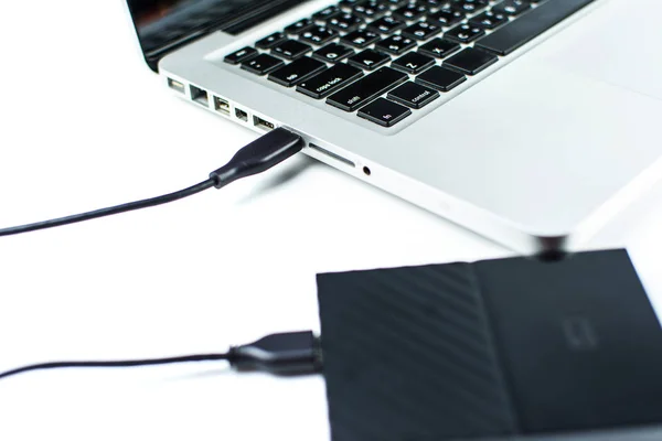 Close up of external hard disk drive for connect to laptop, transfer or backup data between computer and HDD. Black hard disc for backup files and important information using USB 3.0 connection