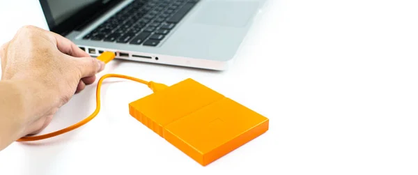 Close up of external hard disk drive for connect to laptop, transfer or backup data between computer and HDD. Black hard disc for backup files and important information using USB 3.0 connection