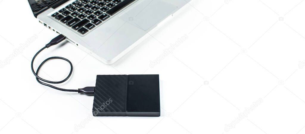 Close up of external hard disk drive for connect to laptop, transfer or backup data between computer and HDD. Black hard disc for backup files and important information using USB 3.0 connection