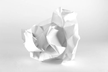 White crumpled paper ball on white background with clipping path. Close-up of crumpled paper ball