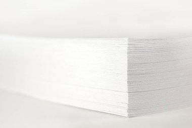 Close up of stack of papers on white background. Office: Pile of Paper